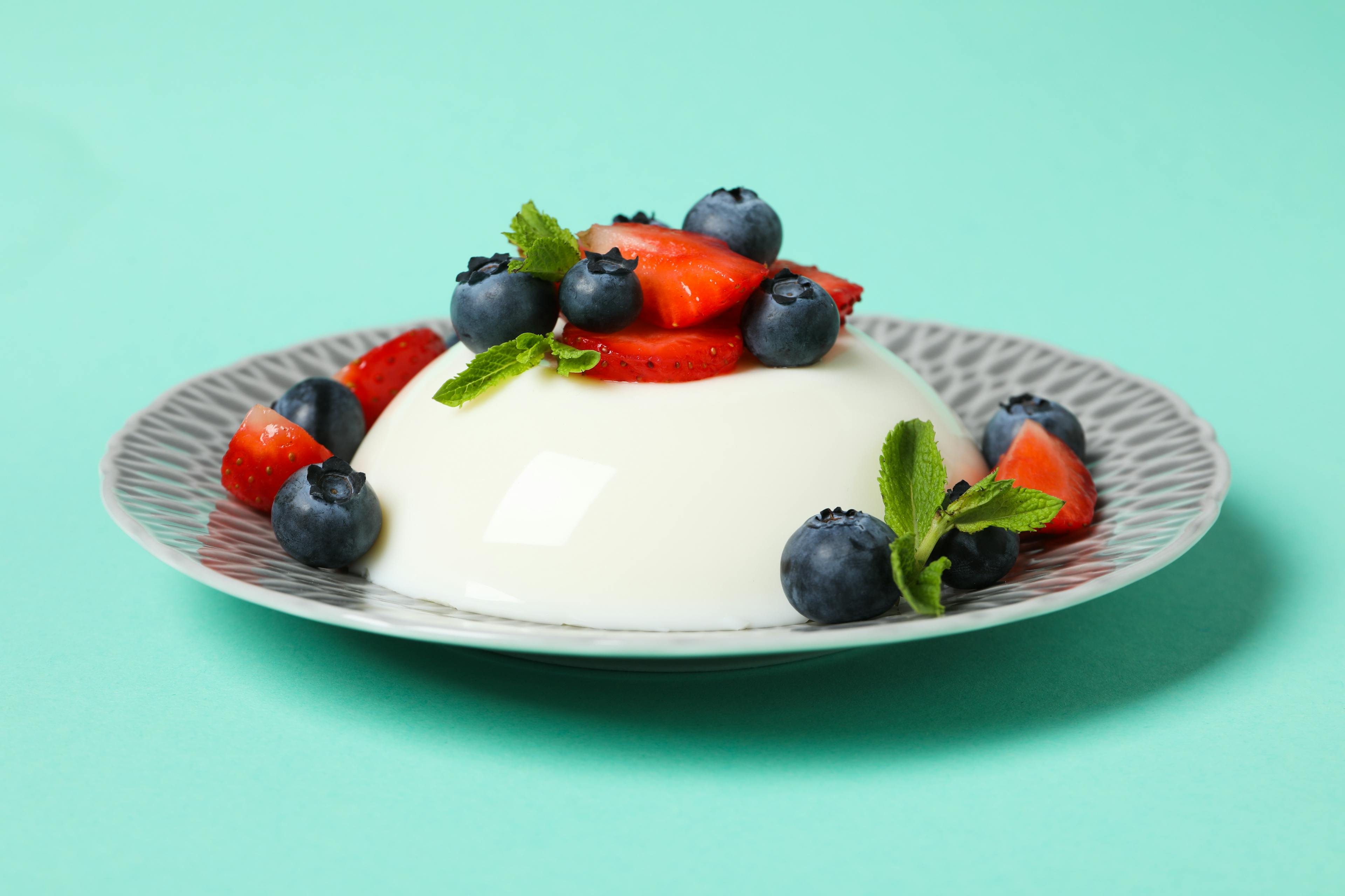 portuguese milk pudding with strawberries, raspberries and bluberries