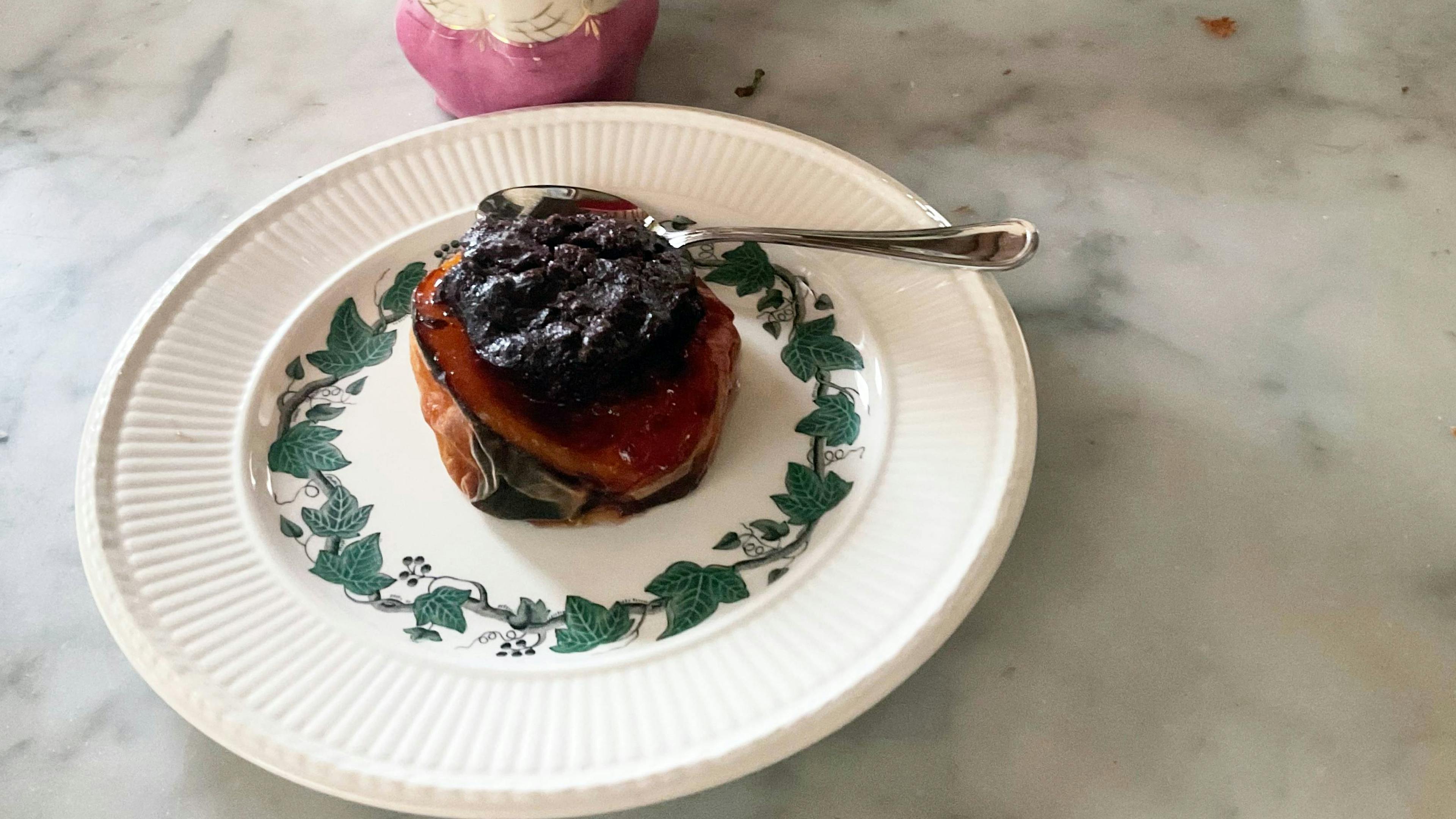Baked stuffed peach served on a small plate