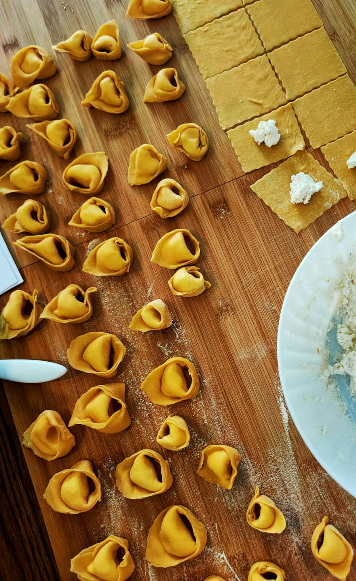 Tortelli on a cutting board with ricotta, cooking class