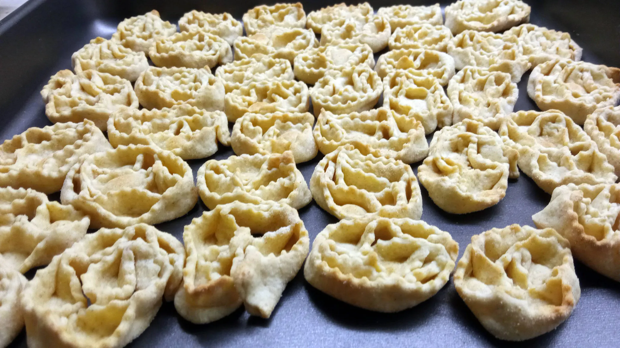 Cartellate, a traditional fried pastry from Puglia, Italy, drizzled with honey or vino cotto, prepared by home cook Cesarina Domenica