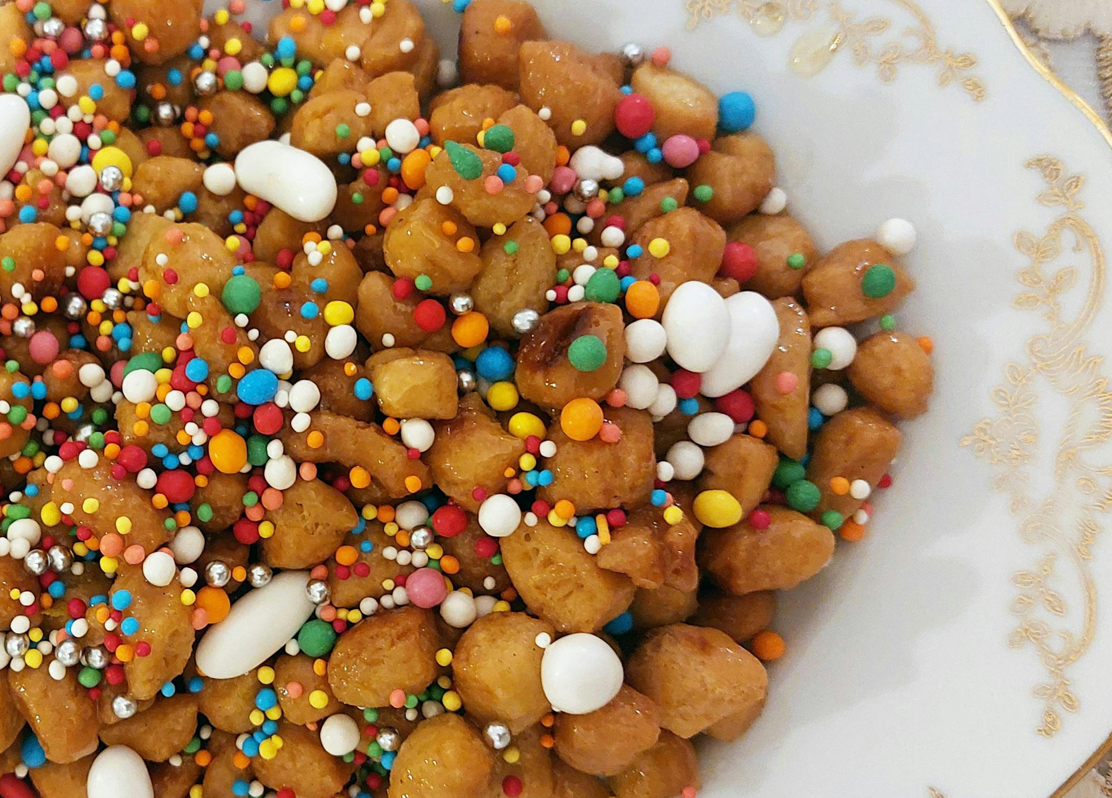 Struffoli, delicious fried dough balls coated in honey and decorated with sprinkles; a must-have on holiday tables in Campania for Christmas and Carnival