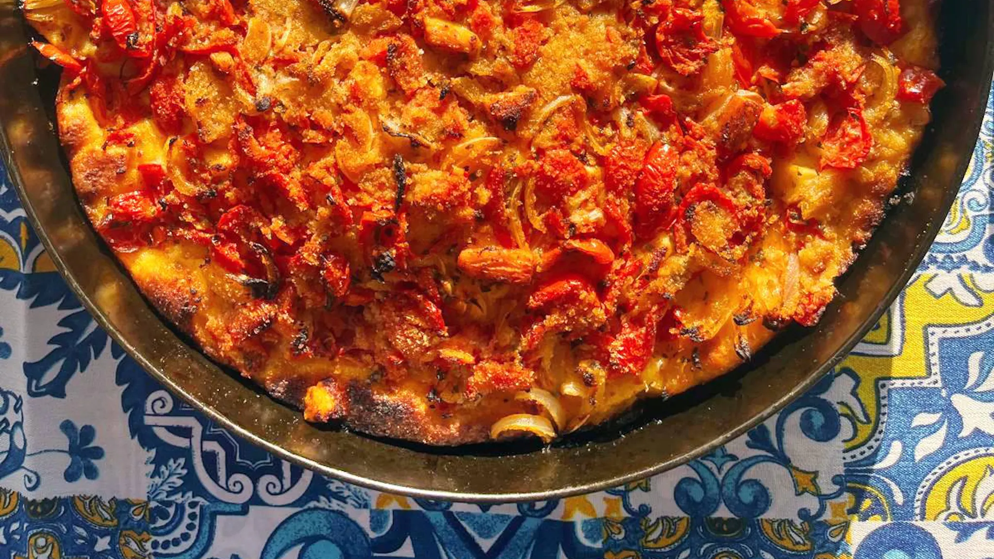 Faccia di Vecchia: soft and flavorful focaccia from Torretta’s tradition, topped with caciocavallo cheese, anchovies, and oregano