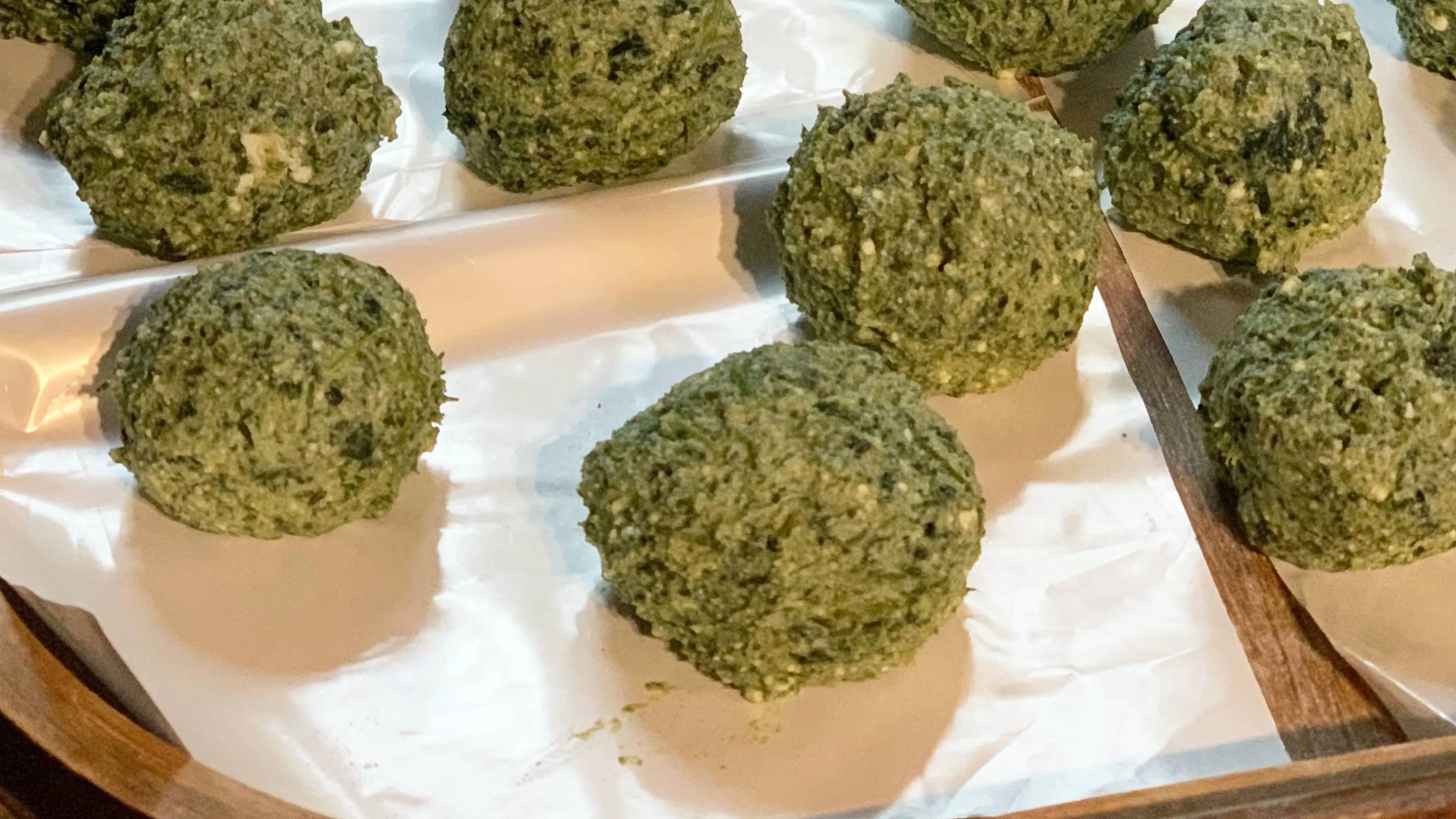 Gnudi with wild field herbs on a baking tray