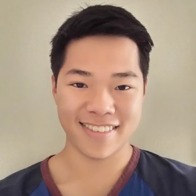 A man in a blue shirt smiles.