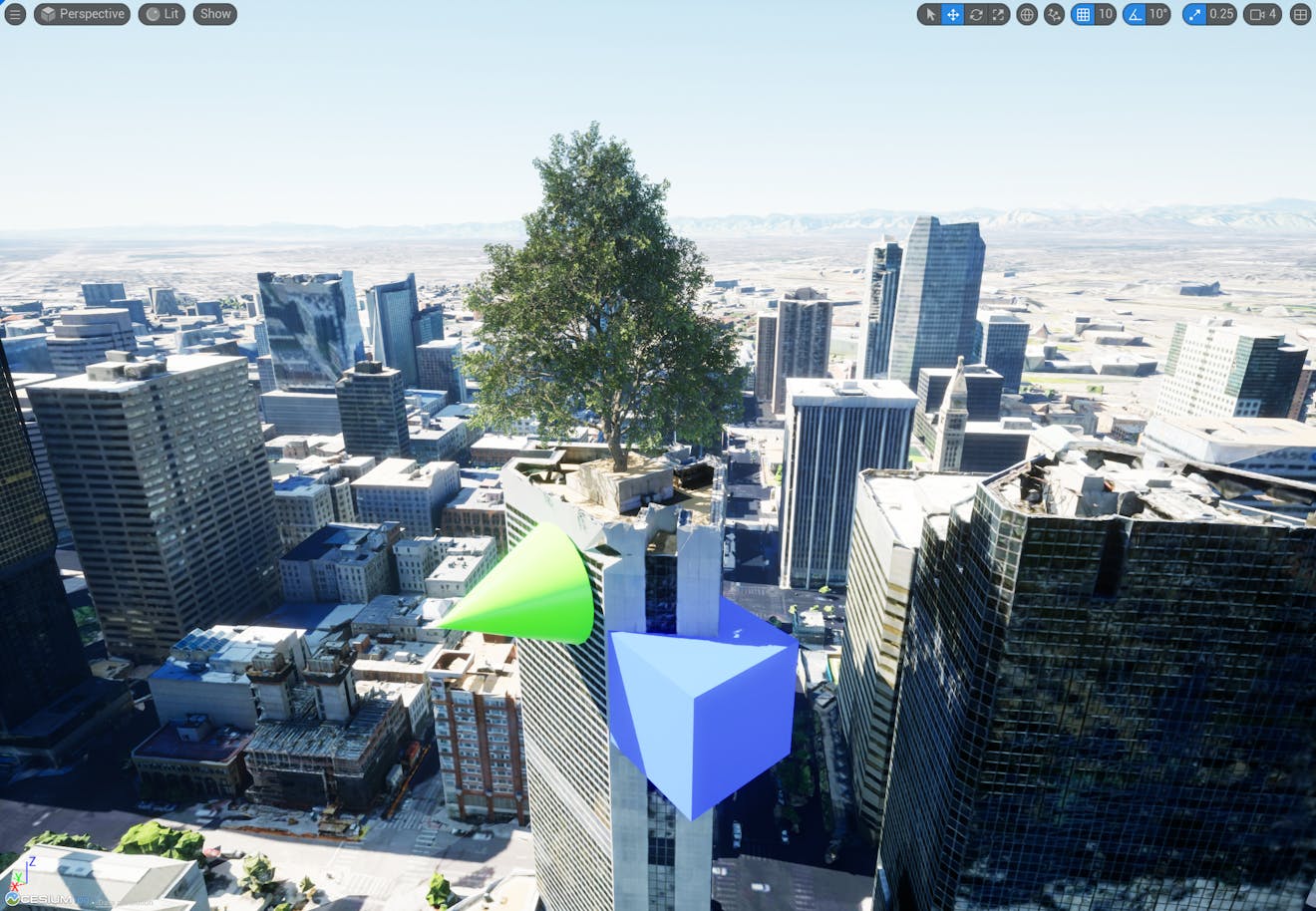 A screenshot of the viewport after a tree, green cone, and blue cube have been added to the level.