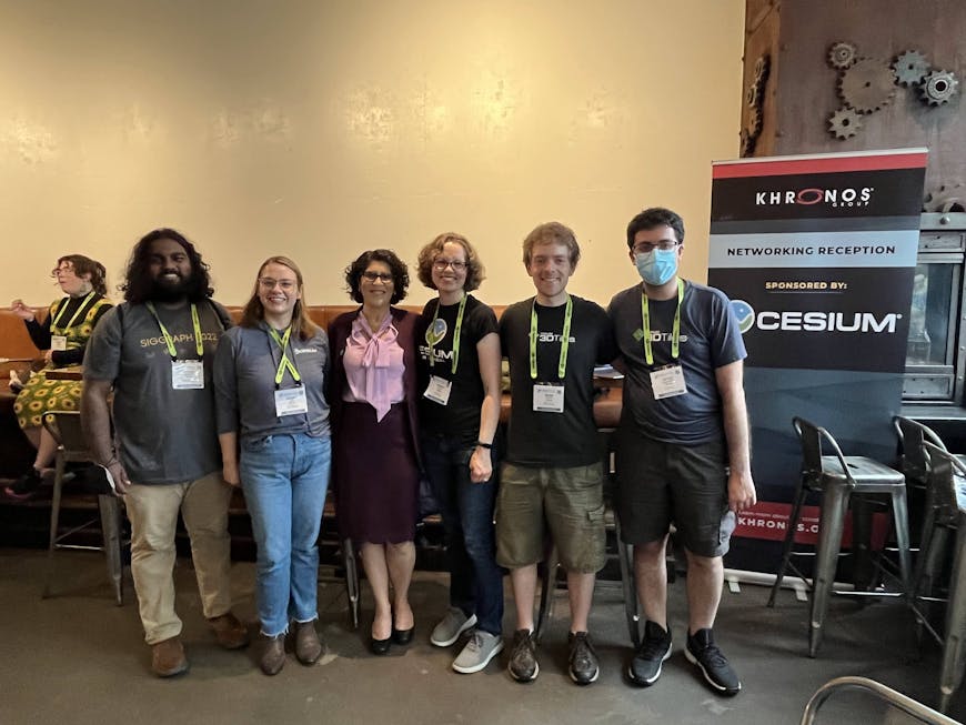 a group of people standing and posing for the camera