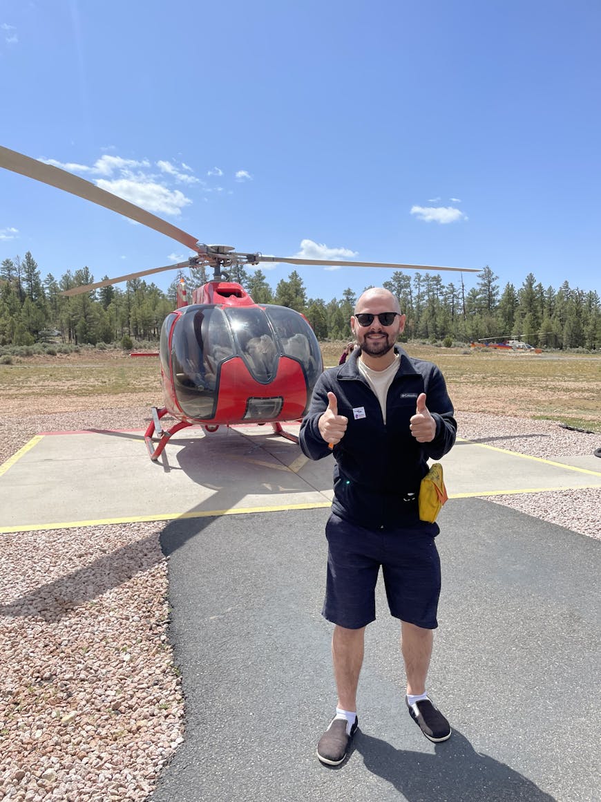 Jake Adelgren by a helicopter