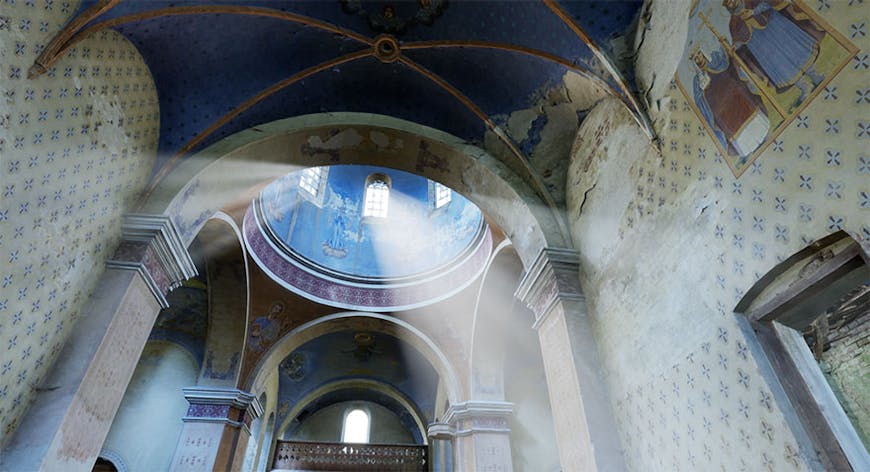 Interior view of the historic Oleszyce Church in Poland, looking up into a domed ceiling painted with blue artwork