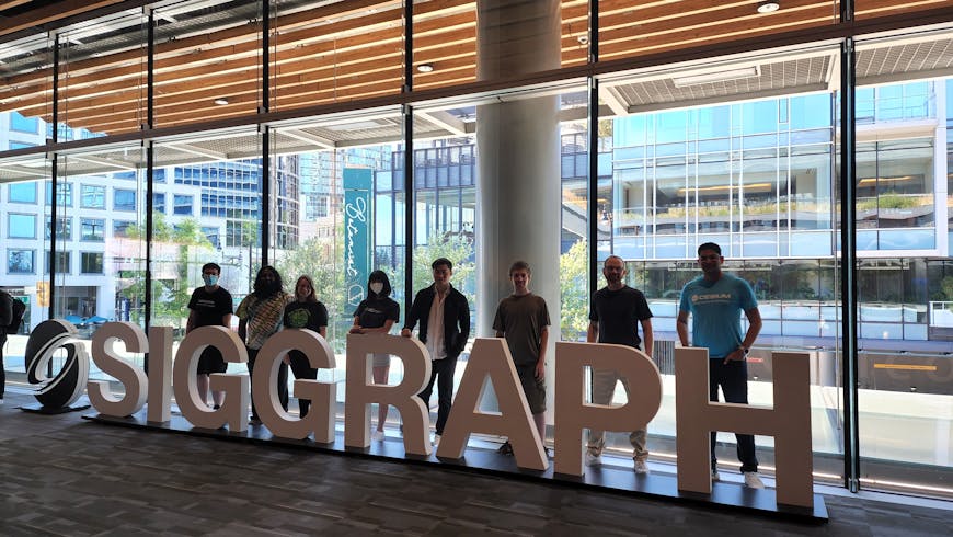 a group of people stand in front of the SIGGRAPH logo