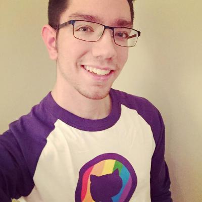 A man with glasses wears a GitHub shirt and smiles.