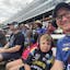 Jason Sobotka and his son at Texas Motor Speedway. They wear branded racing shirts and ear protection.