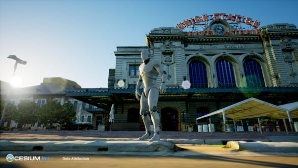 A ground-level view of Union Station in Denver, seen in Unreal Engine. A UE male mannequin is standing on the sidewalk. 