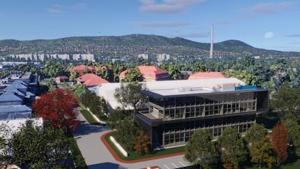 Archicad design with Google Maps Platform’s Photorealistic 3D Tiles in Cesium for Omniverse. A two-story building with many windows, on a tree-lined street, faces the viewer. Mountains are in the background.