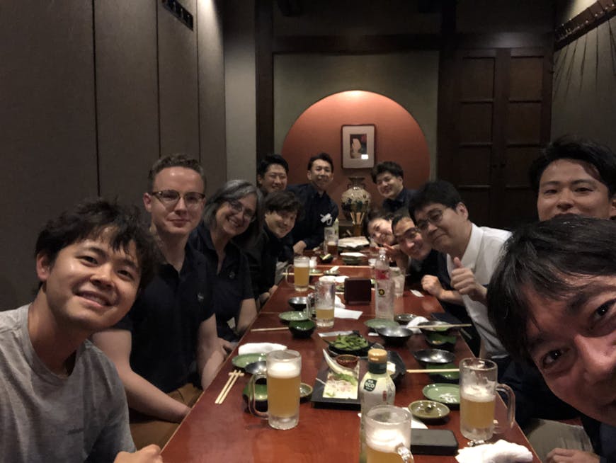Members of the Cesium and EARTHBRAIN teams enjoy a shared meal in Japan. 