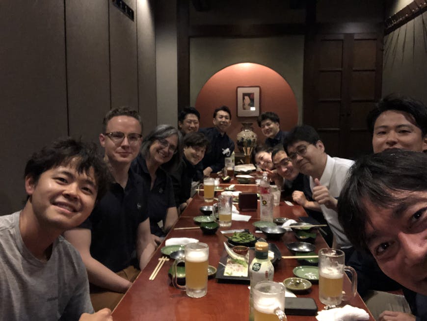 Members of the Cesium and EARTHBRAIN teams enjoy a shared meal in Japan.