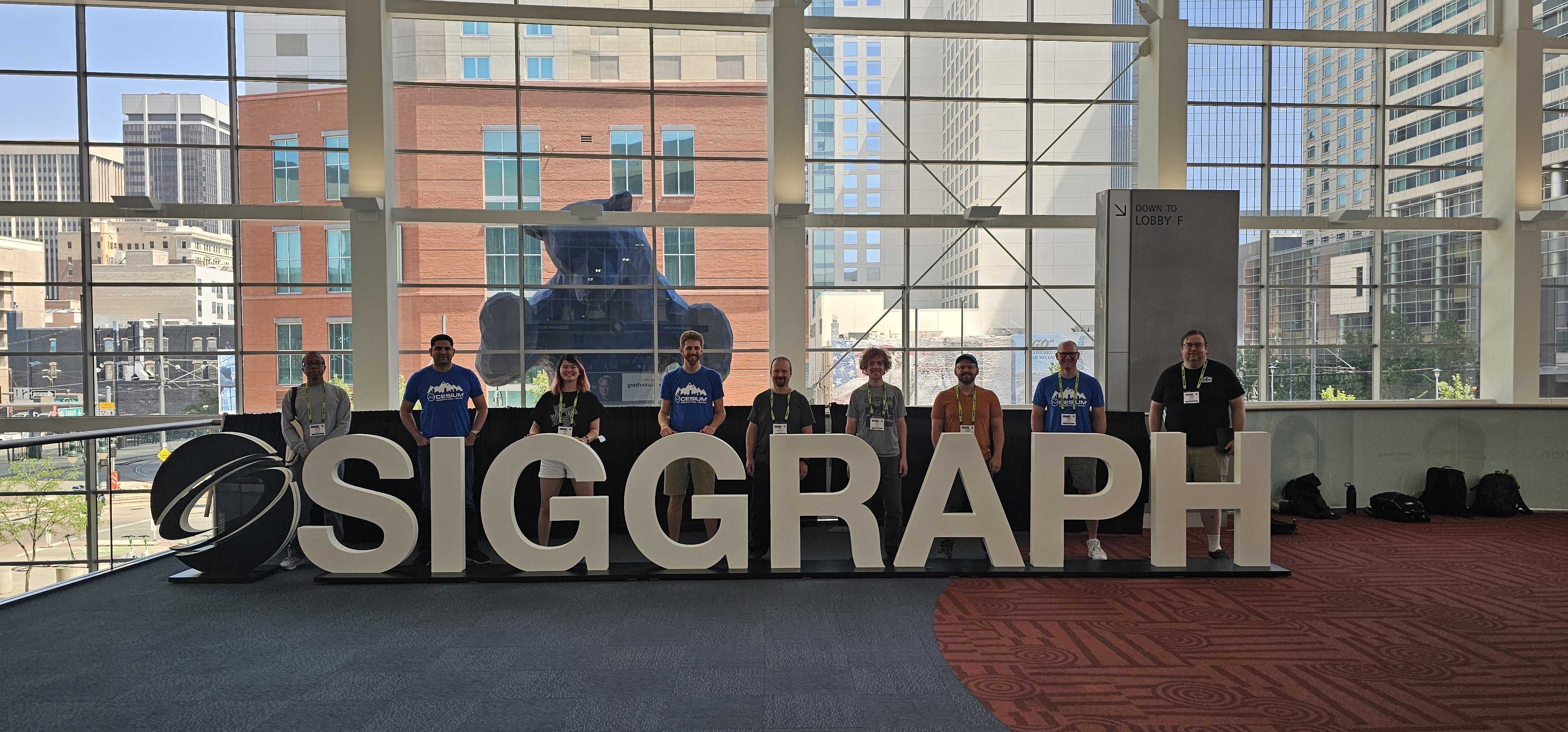 Cesium team members at SIGGRAPH 2024, in front of the iconic Blue Bear at the Colorado Convention Center.