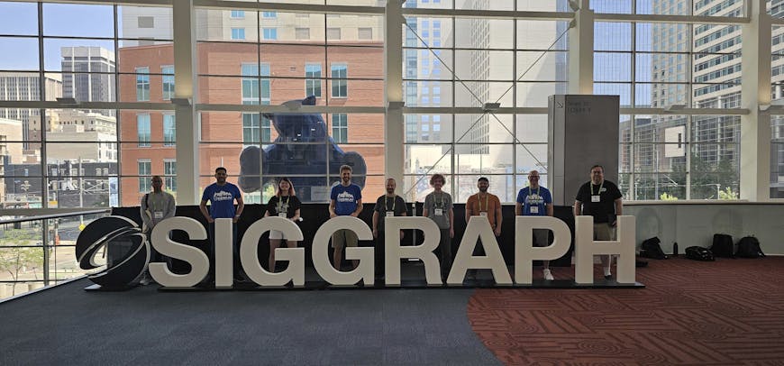 Cesium team members at SIGGRAPH 2024, in front of the iconic Blue Bear at the Colorado Convention Center.