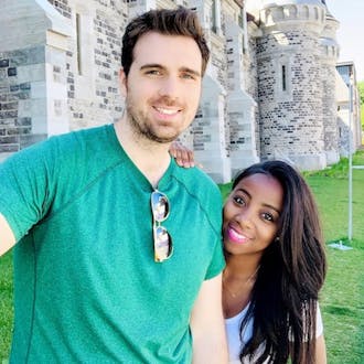 Ben Jewett with a young woman in front of a castle