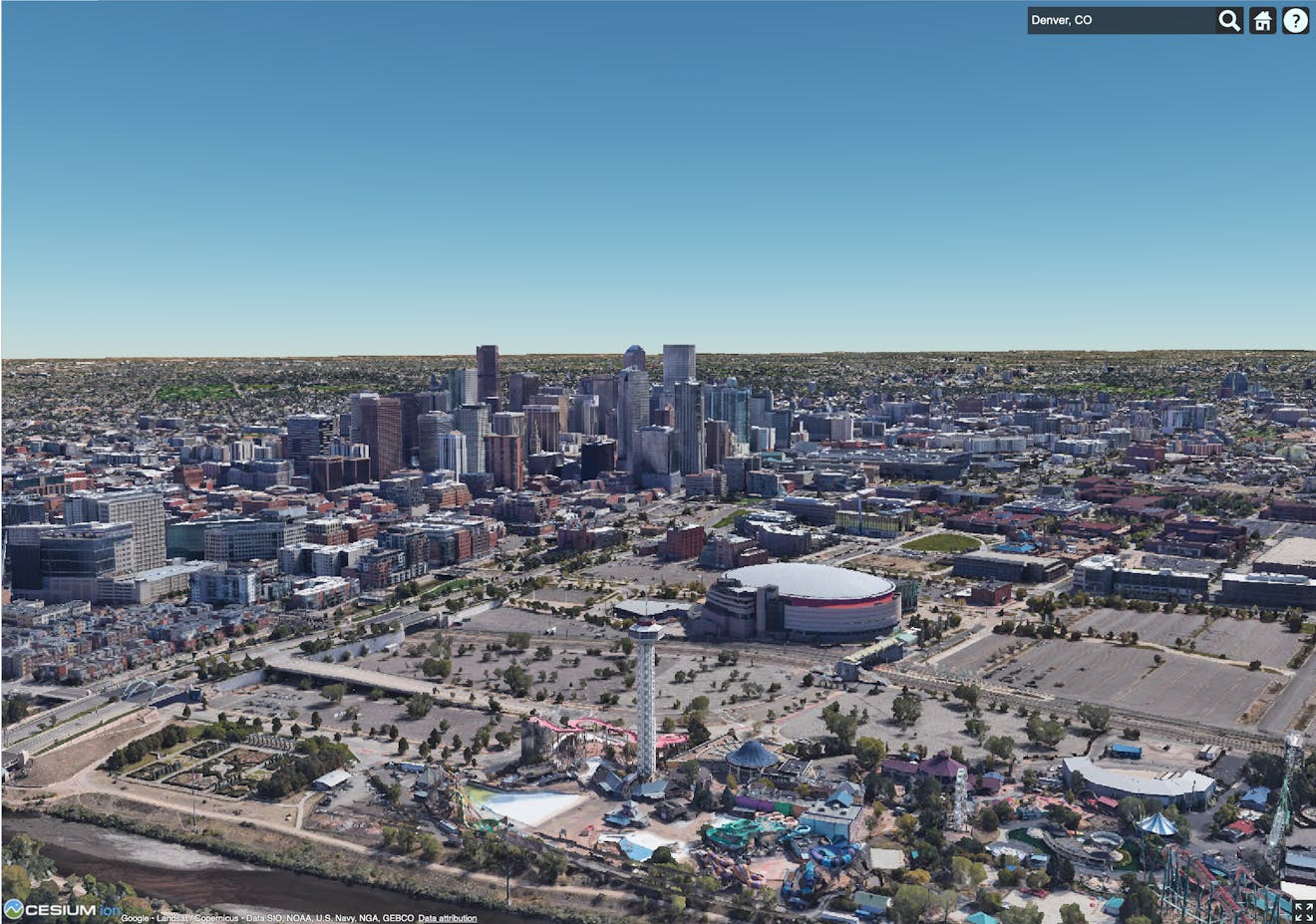 Denver, Colorado, USA, using Photorealistic 3D Tiles in CesiumJS. Elitch Gardens is in the foreground, Ball Arena toward the middle, and the downtown skyline in the back.