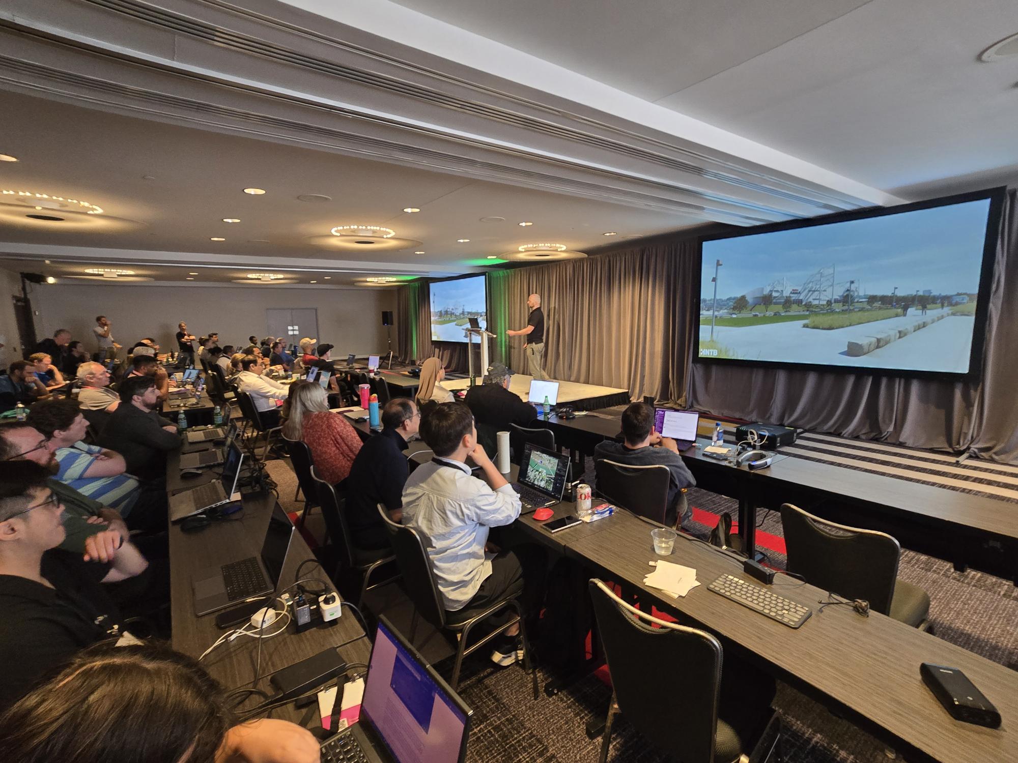 A group observes a talk at the 2025 Cesium Developer Conference