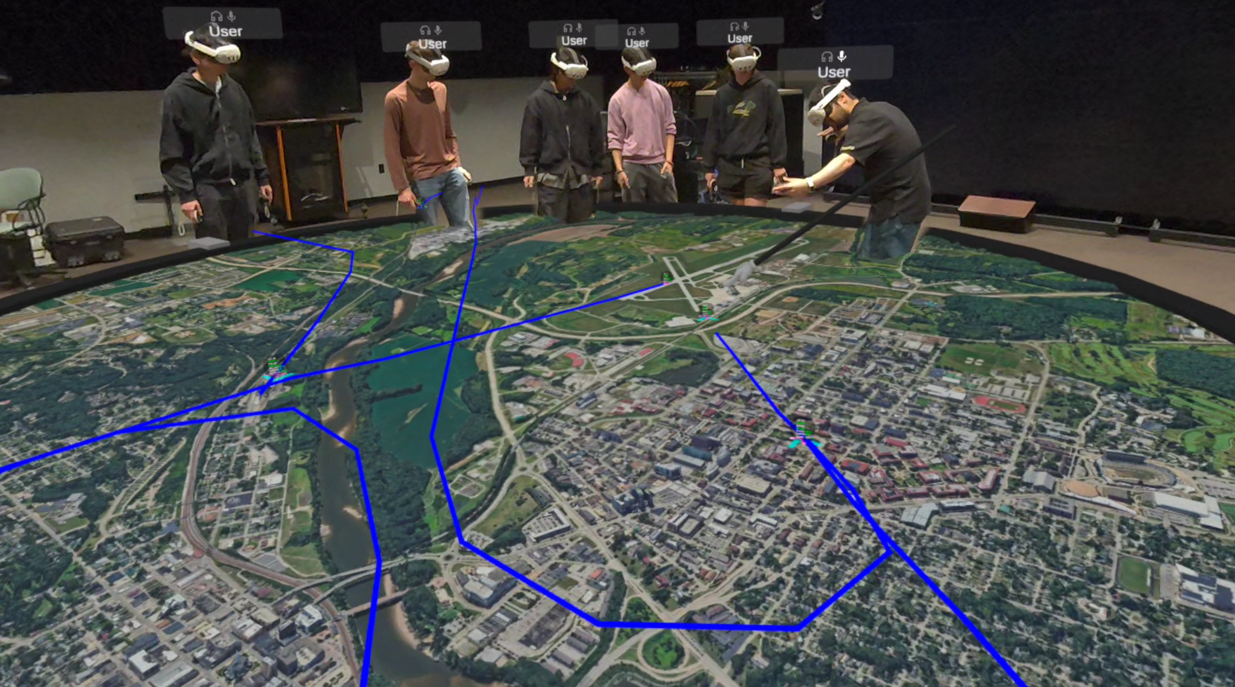 Viewers looking at live flight data visualized in VR with CollabXR by Purdue University Envision Center