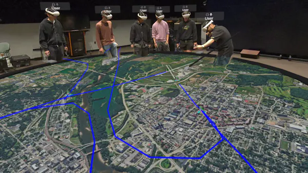 Viewers looking at live flight data visualized in VR with CollabXR by Purdue University Envision Center