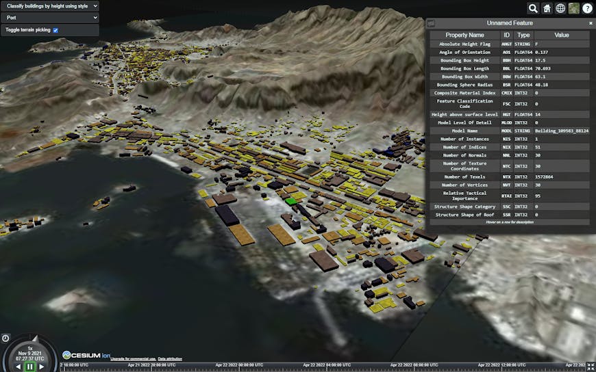 Screenshot showing buildings classified by height with metadata included with 3D Tiles Next. Buildings are yellow, tan, brown, black, and green. The buildings are surrounded by mountains and water.