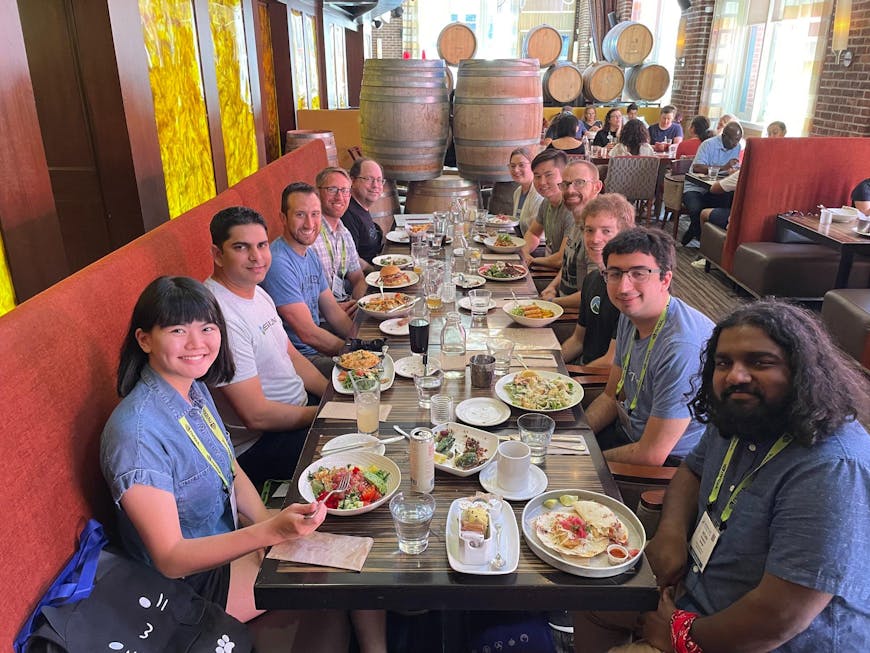 a group of people gathered around a table for lunch