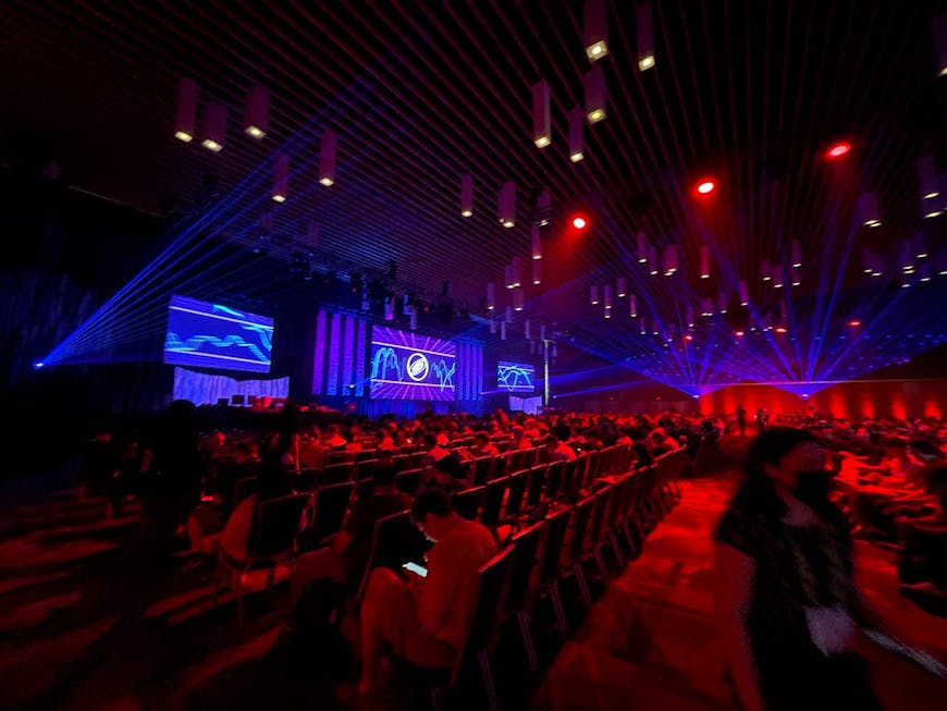 a large ballroom with the lights dimmed