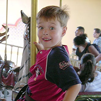Josh Rouzer on a carousel as a child.