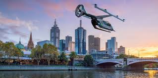 concept image of an aerial Uber vehicle flying over a river at the edge of a city skyline at sunset