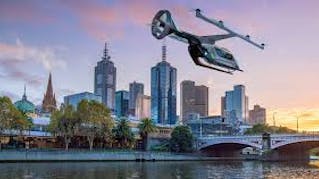 concept image of an aerial Uber vehicle flying over a river at the edge of a city skyline at sunset