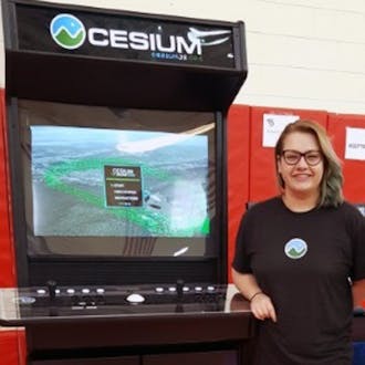 Gabby Getz with a Cesium branded arcade game.
