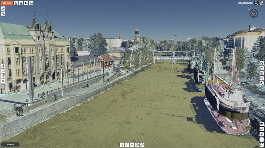 3D model using CityGML and point clouds. On the left is a tall, wide building with a green roof. In the middle is a waterway. On the right are ships.