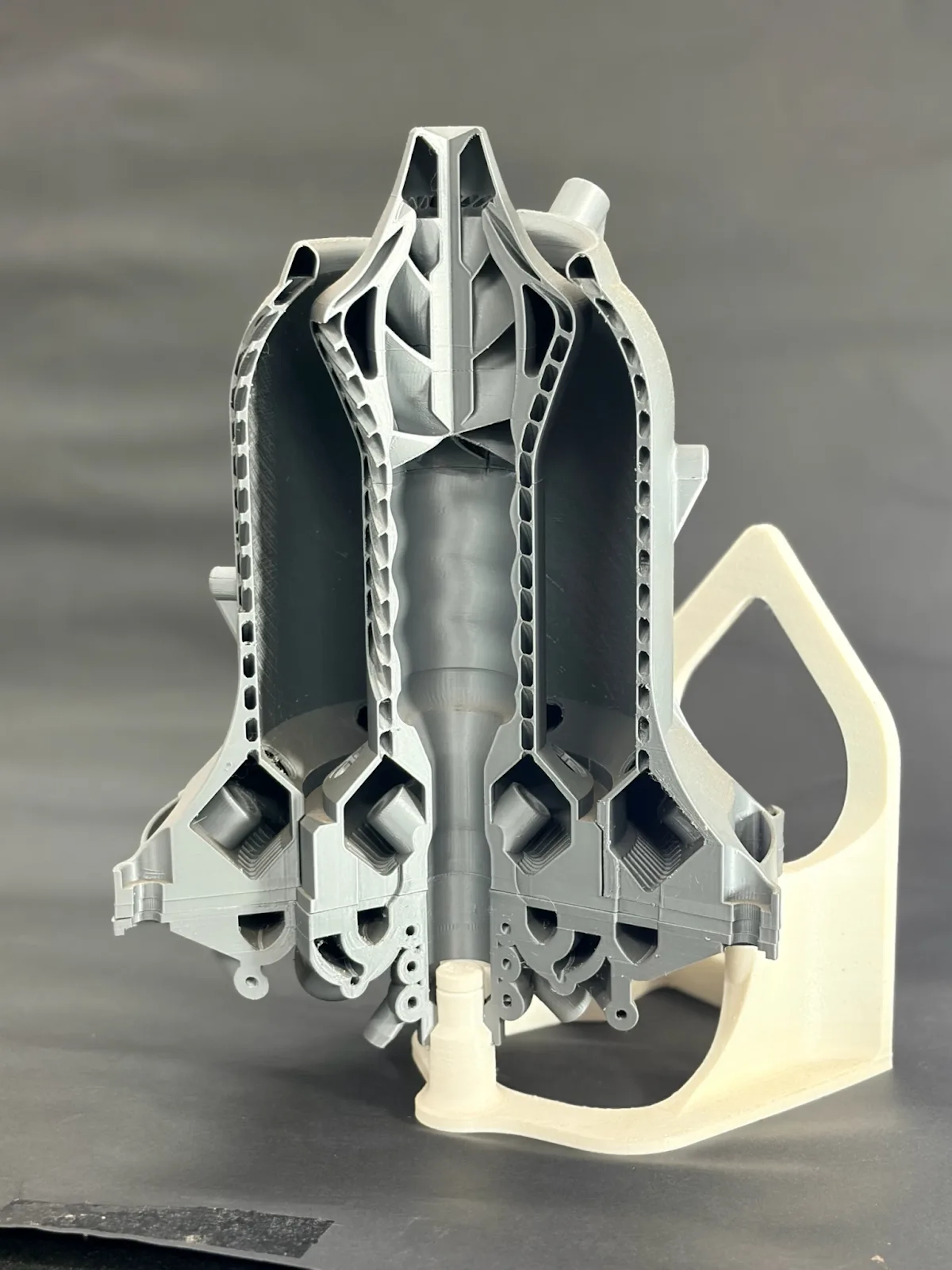 Multi-part rocket engine nozzle assembly printed in grey and white