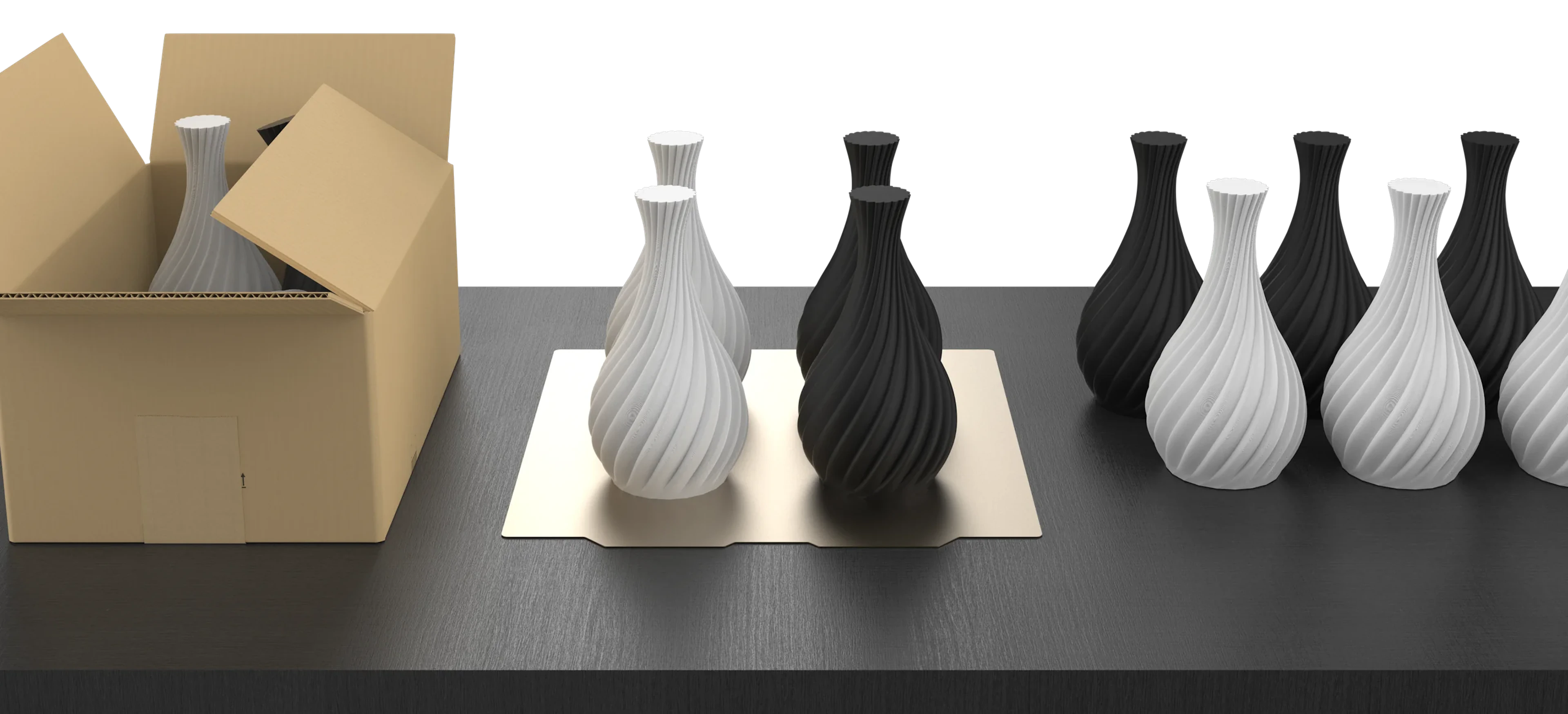 A build plate holding a white and a black vase printed side by side, next to a row of finished vases and a shipping box being packed