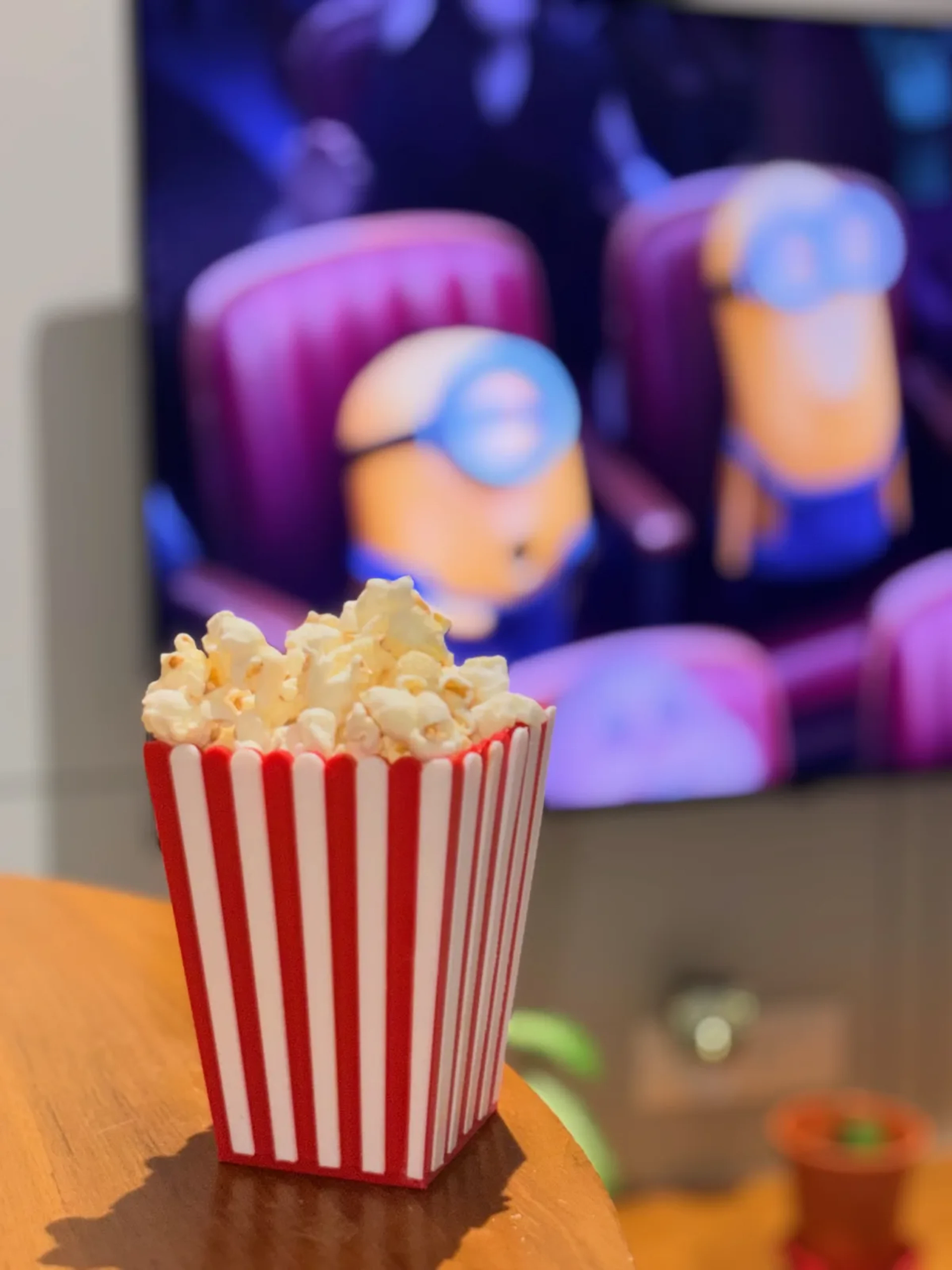 Striped popcorn box filled with printed popcorn