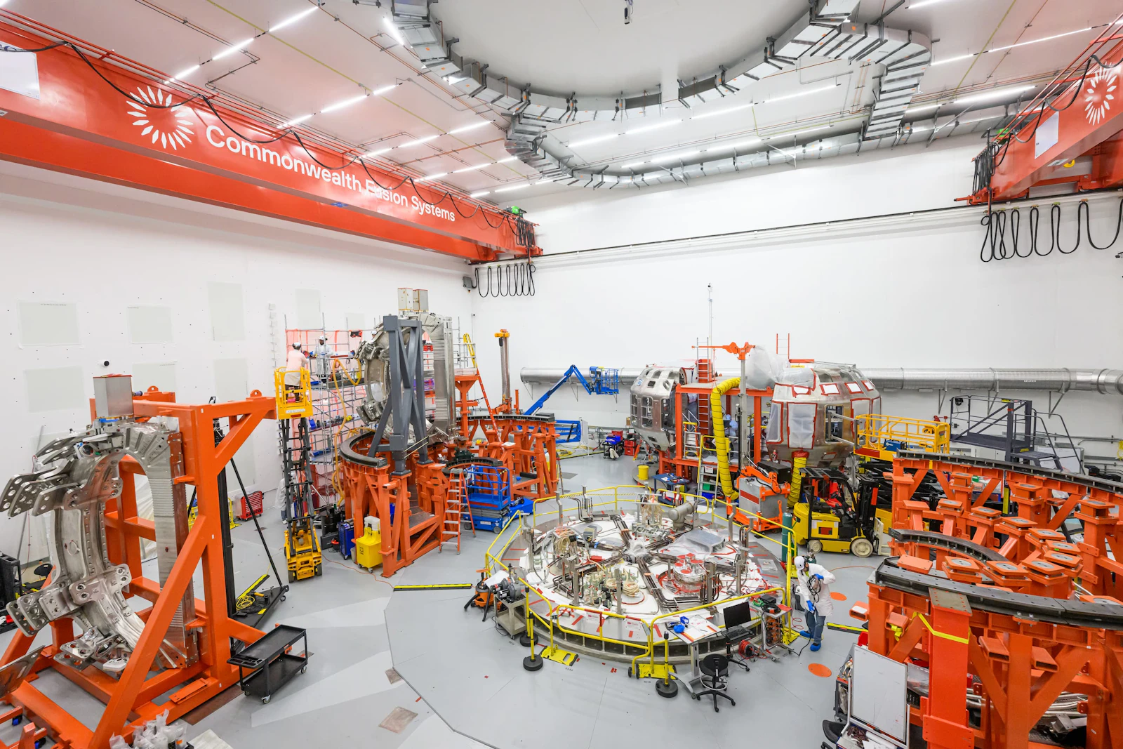 CFS tokamak hall with both halves of the vacuum vessel, the cryostat base, and three toroidal field (TF) magnets in the room