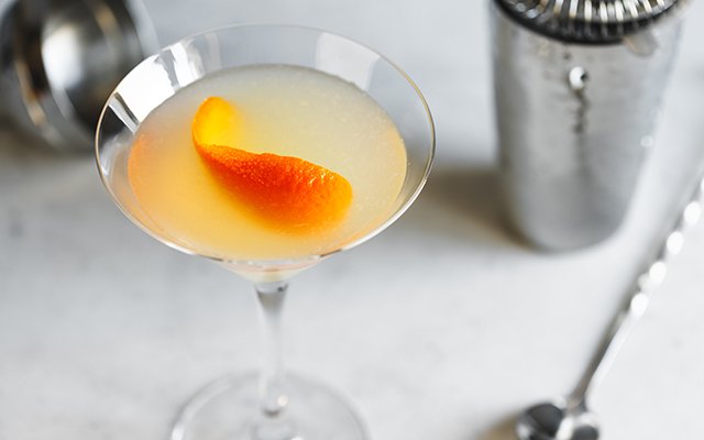 Yellow pale Corpse Reviver No. 2 gin cocktail from the Prohibition era inside a clear martini glass