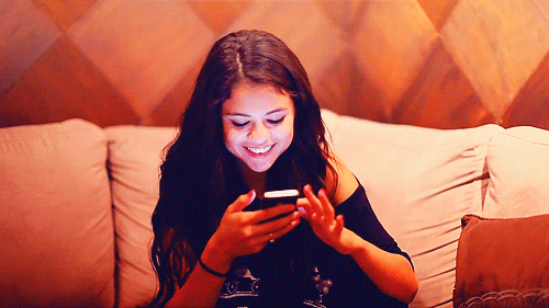 scrolling through phone laughing GIF.gif