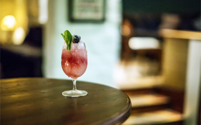 Signature cocktail gin bramble with mint and blackberry