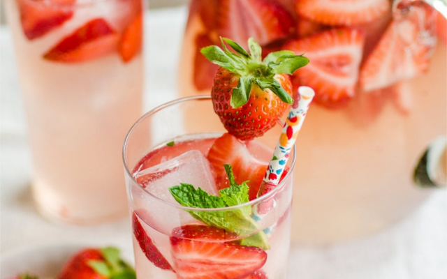 Strawberry Occitan Gin and Tonic Cocktail over ice with strawberries and mint