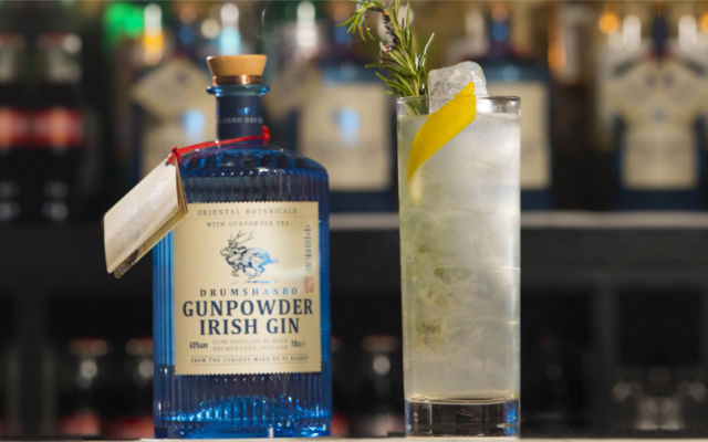 Elderflower & rosemary collins gin cocktail of the week with lemon and rosemary sprig garnish over ice