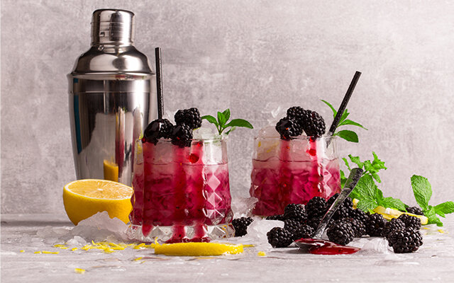 Bramble cocktails with blackberry garnish