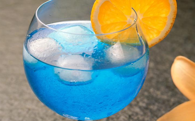 Blue gin and tonic with orange