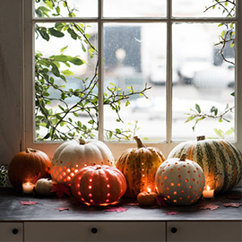 Pretty for a mantelpiece or windowsill! Carve a few polka dot holes into your pumpkin in various designs and let that twinkly light shine through! (Via Delta-Breezes)