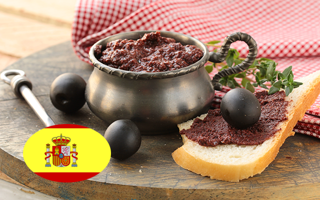 Black Olive Tapenade in a bowl witholives