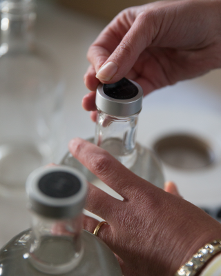 Rachel Hall sticking labels to the Lighthouse gin