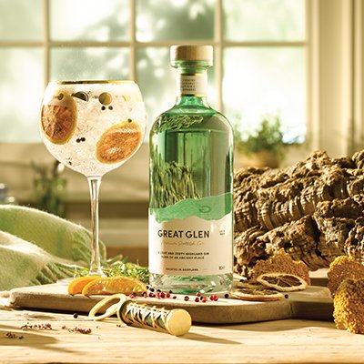 A bottle of Great Glen Gin next to a G&T in a copa glass
