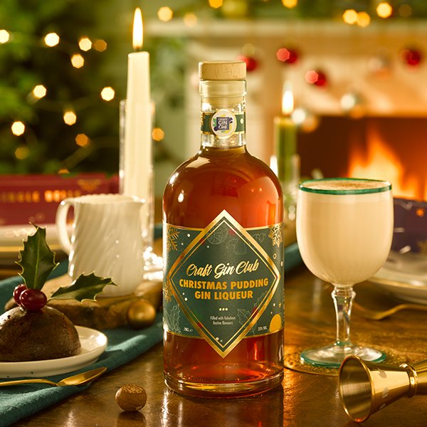 A festive Christmas Dinner Table with a bottle of Craft Gin Club's Christmas Pudding Gin Liqueur